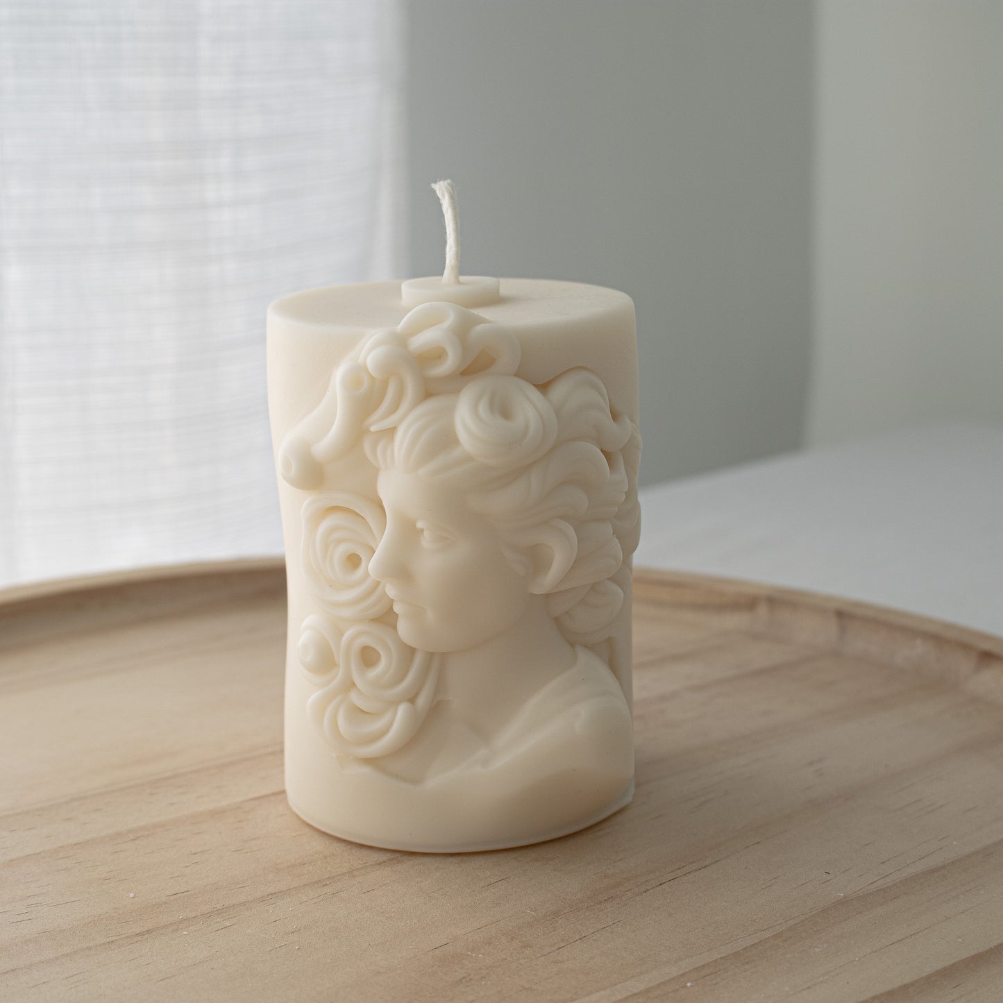 Hellenistic-style sculptural soy candle with a detailed Greek woman’s head design