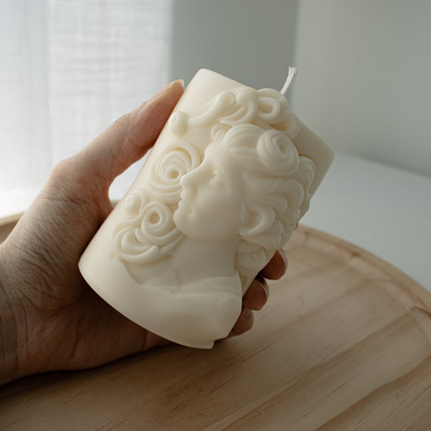 Sculptural candle with a classical Hellenistic woman’s profile and flowing hair