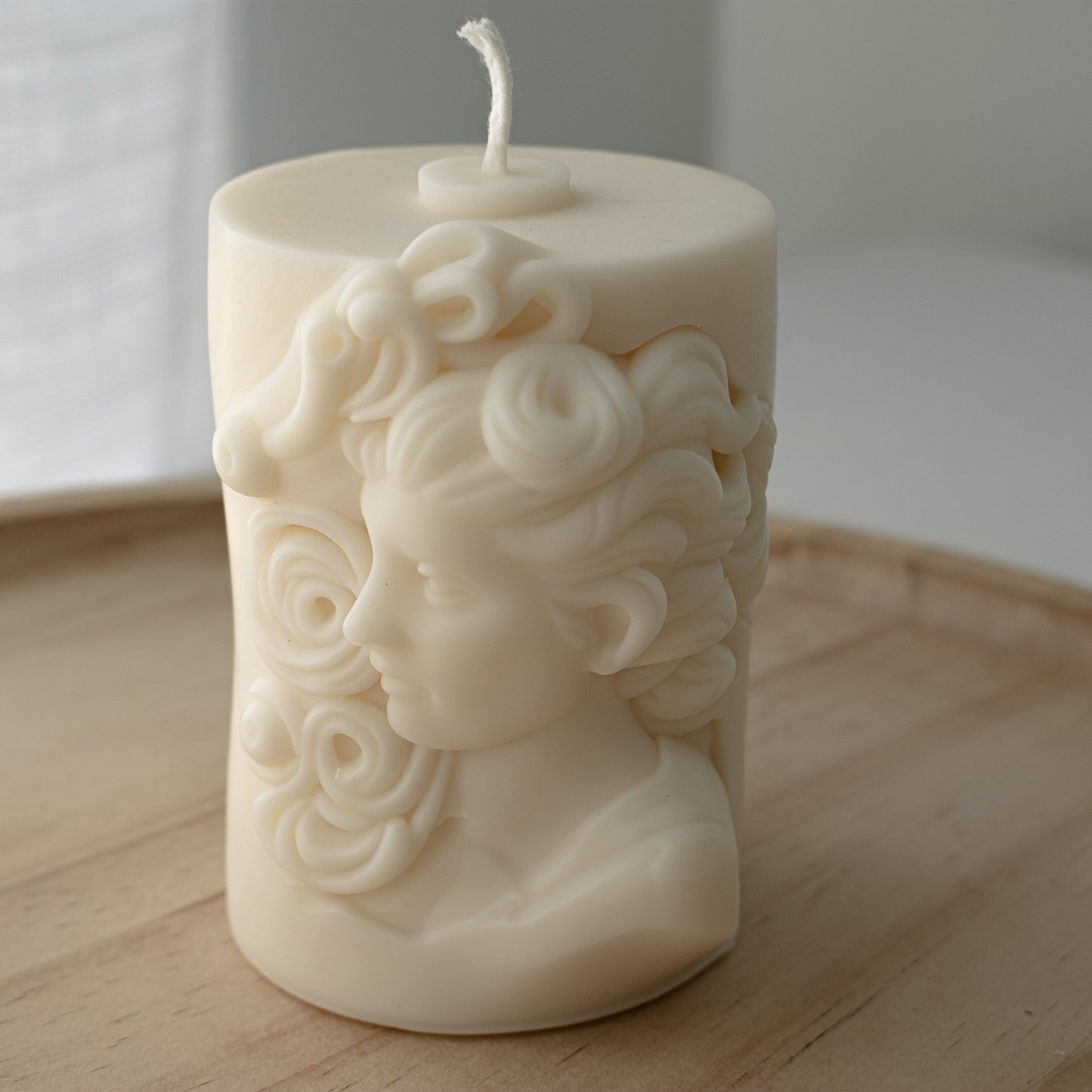 Candle artfully molded with a Mediterranean sculptural woman head in profile
