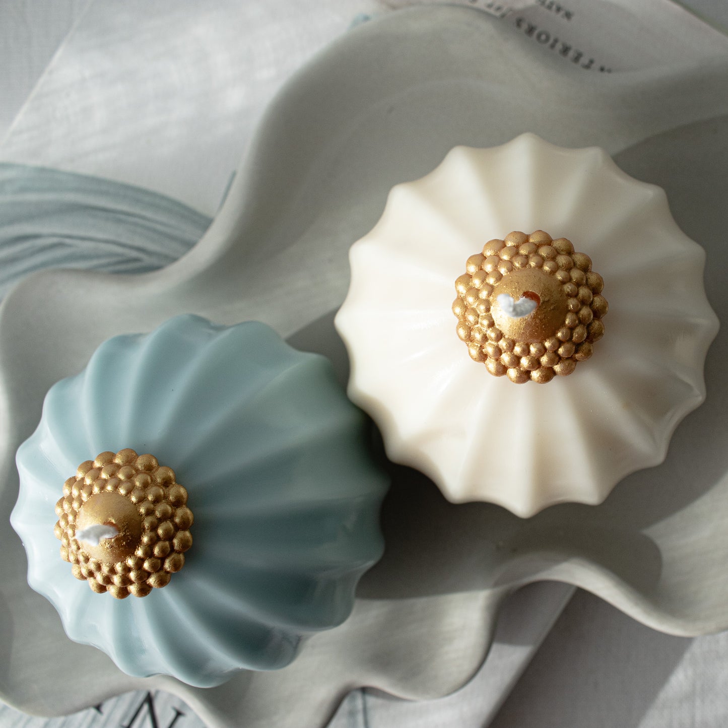 minimalistic, two shiny pillar candle in blue and white with gold top