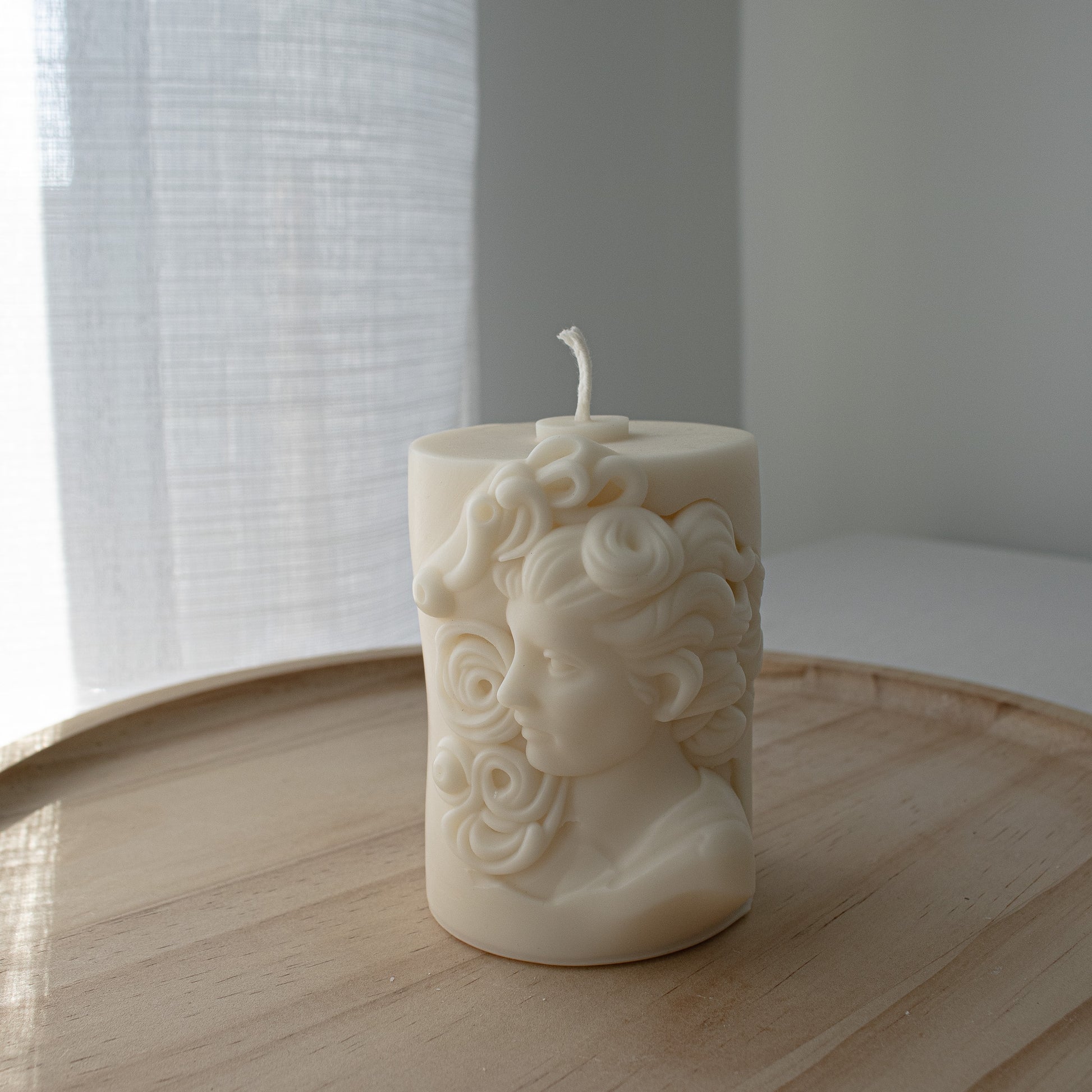 Greek-style soy candle featuring a sculptural bust of a woman in classical form