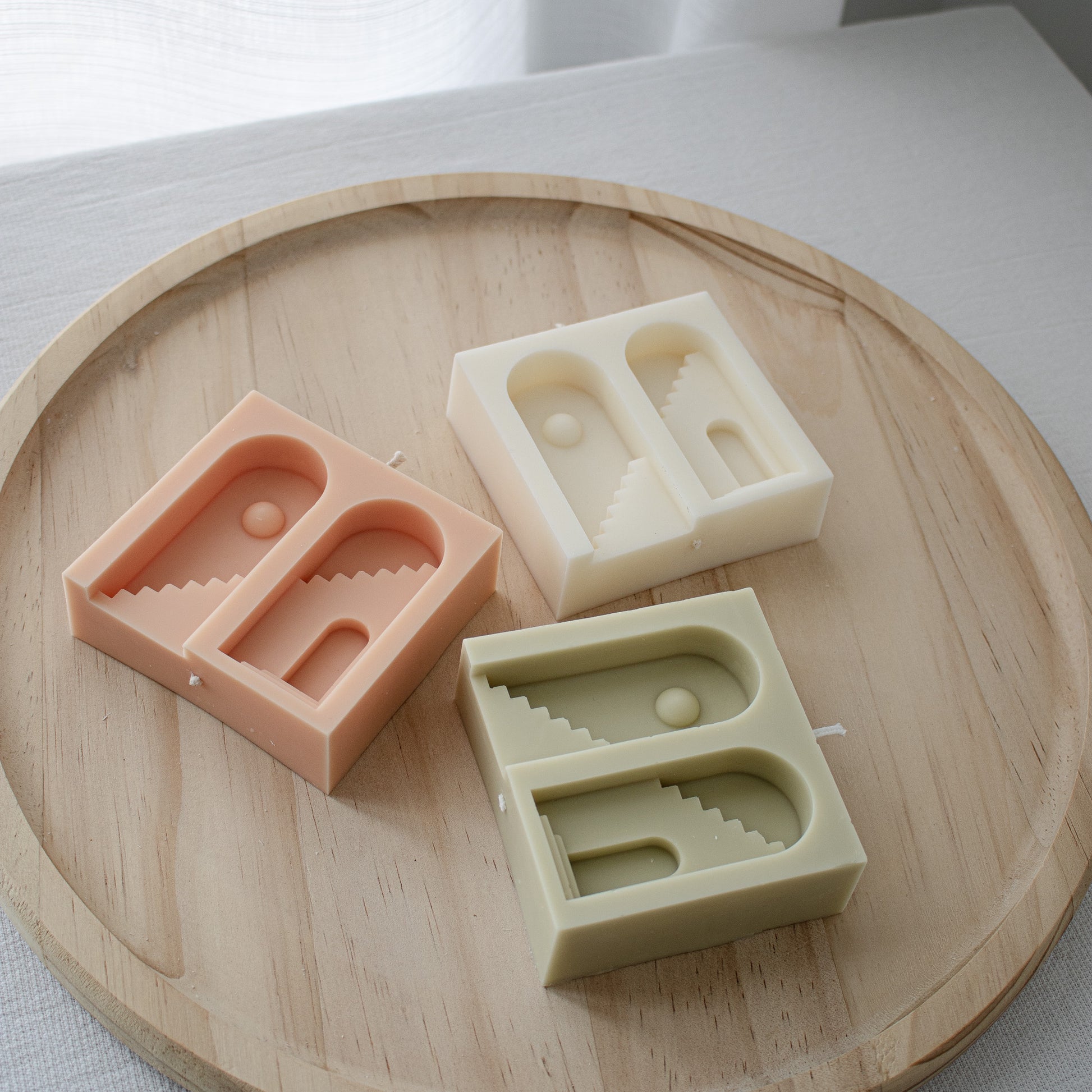 architectural decor candle in peach and olive