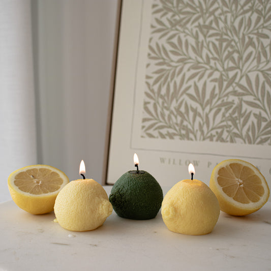 lemon-shaped candles with green and yellow colors on a surface