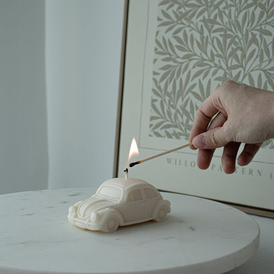 Car-shaped candle being lit 