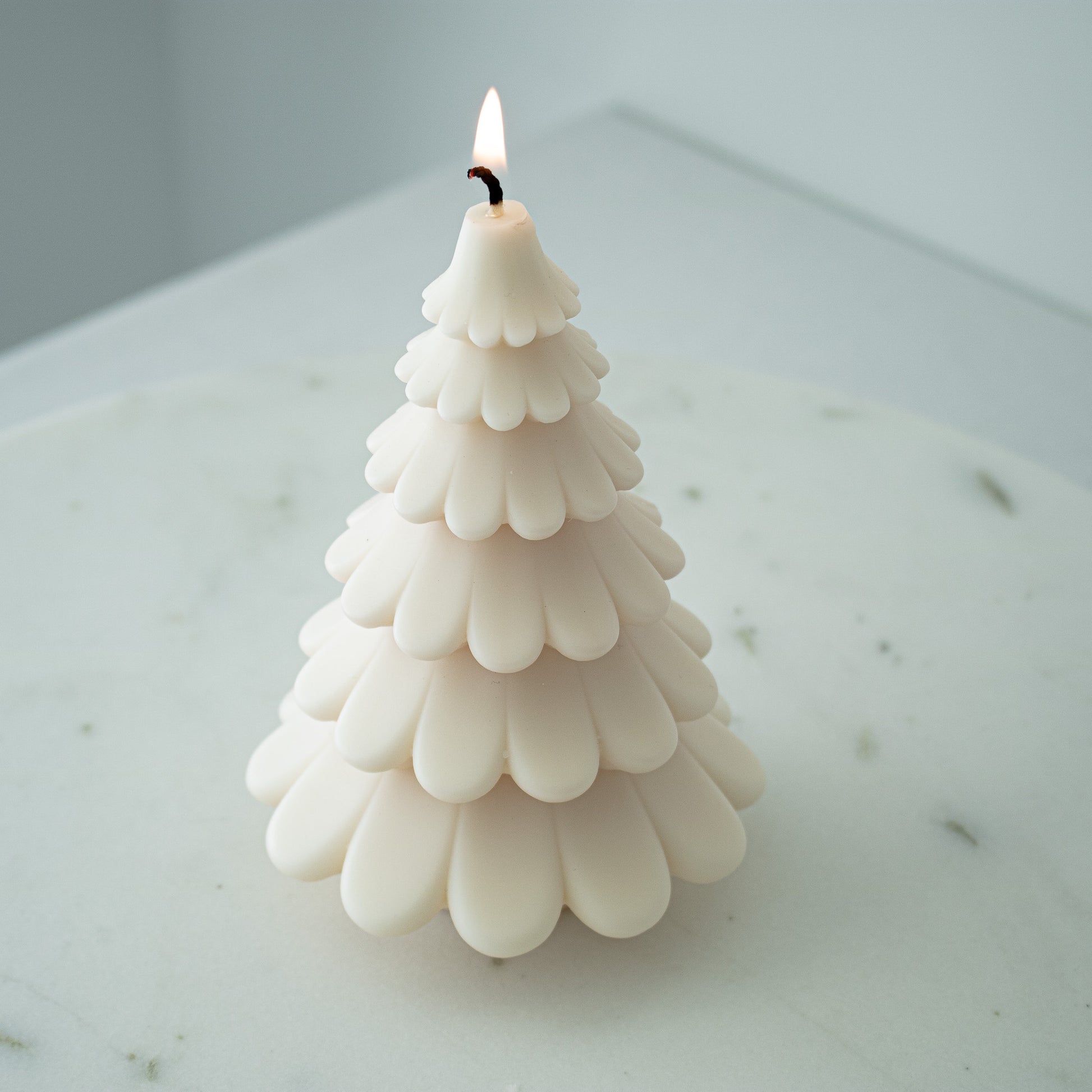 christmas tree shaped candle in cream white