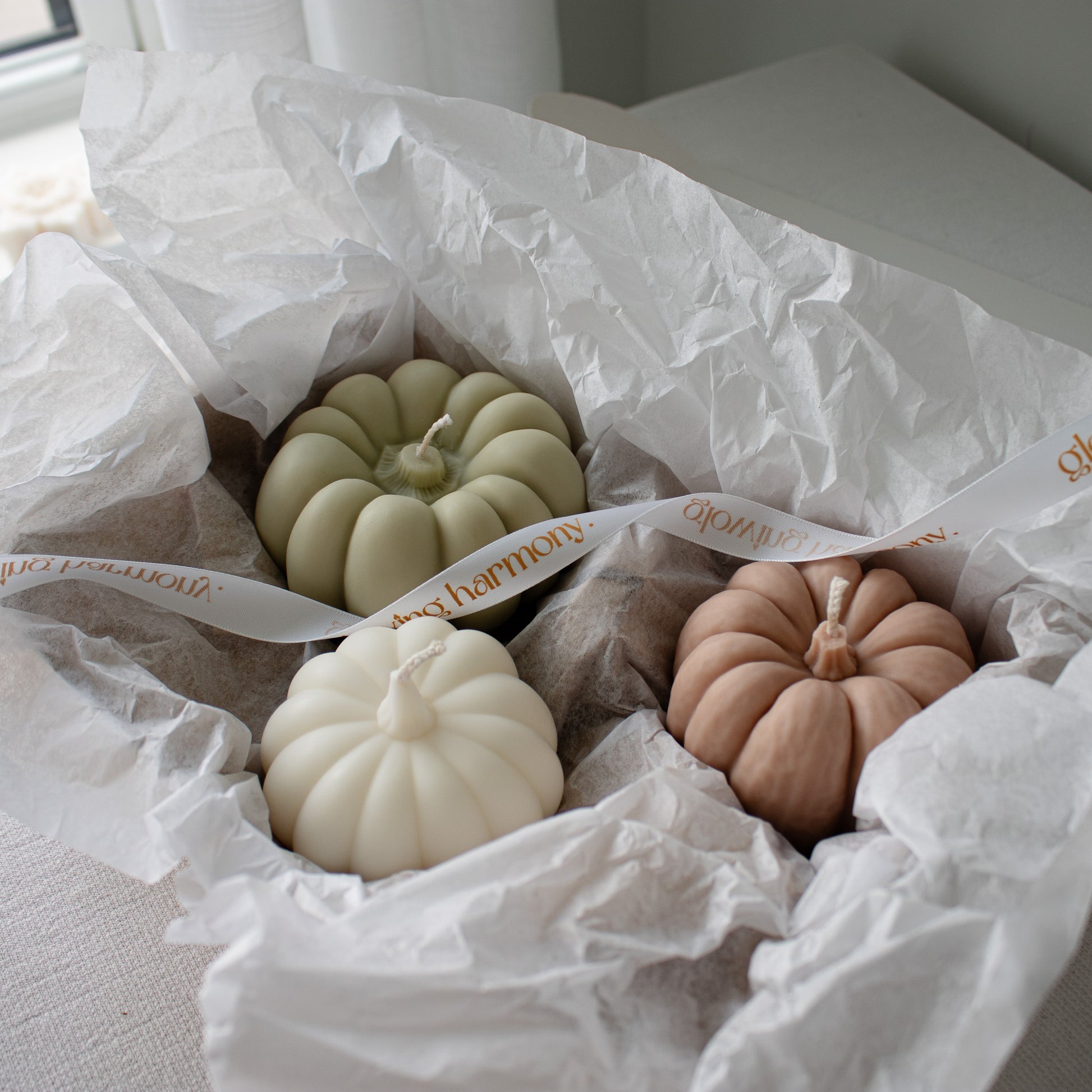Pumpkin-shaped soy wax candles in a gift box