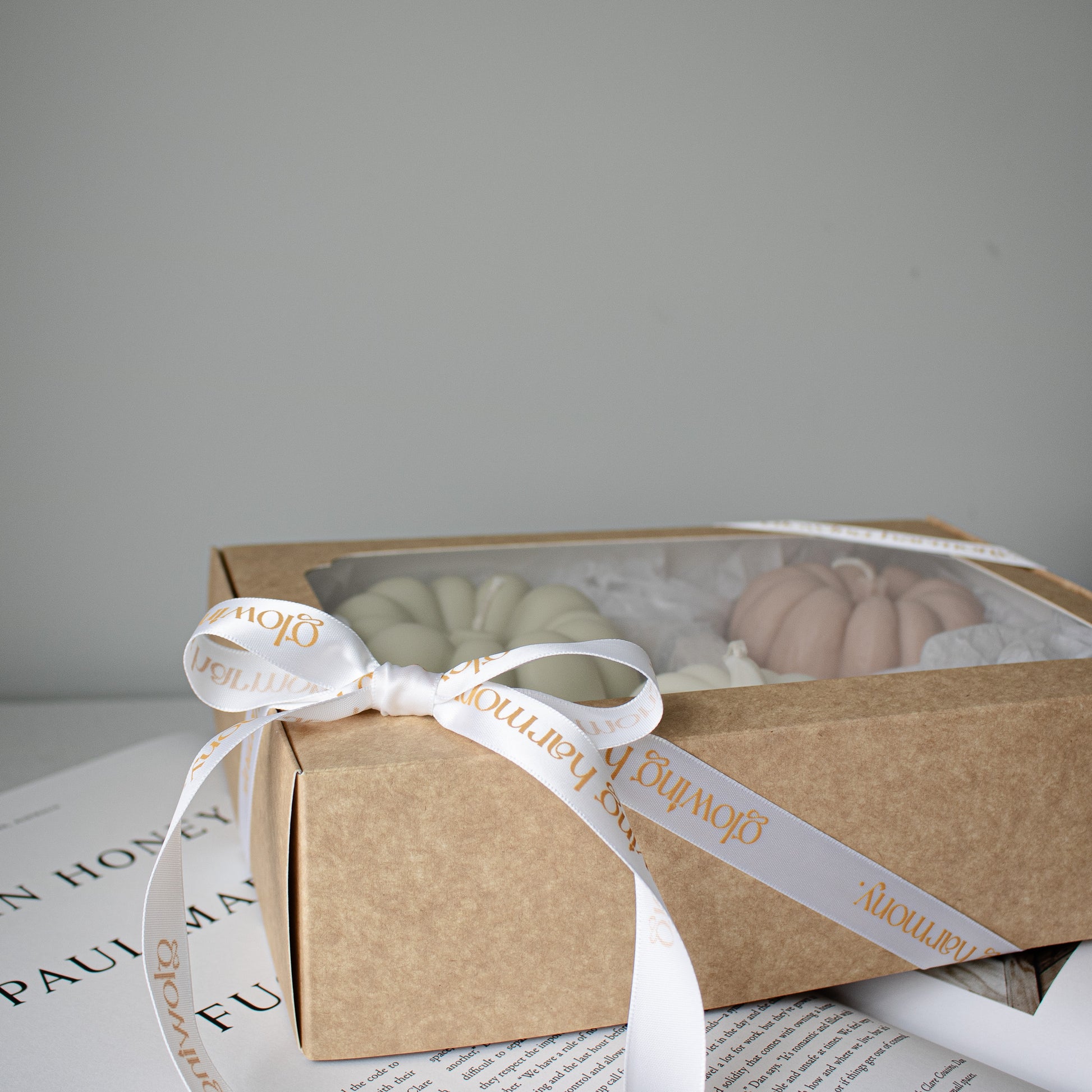 Handmade pumpkin candles in a rustic gift box