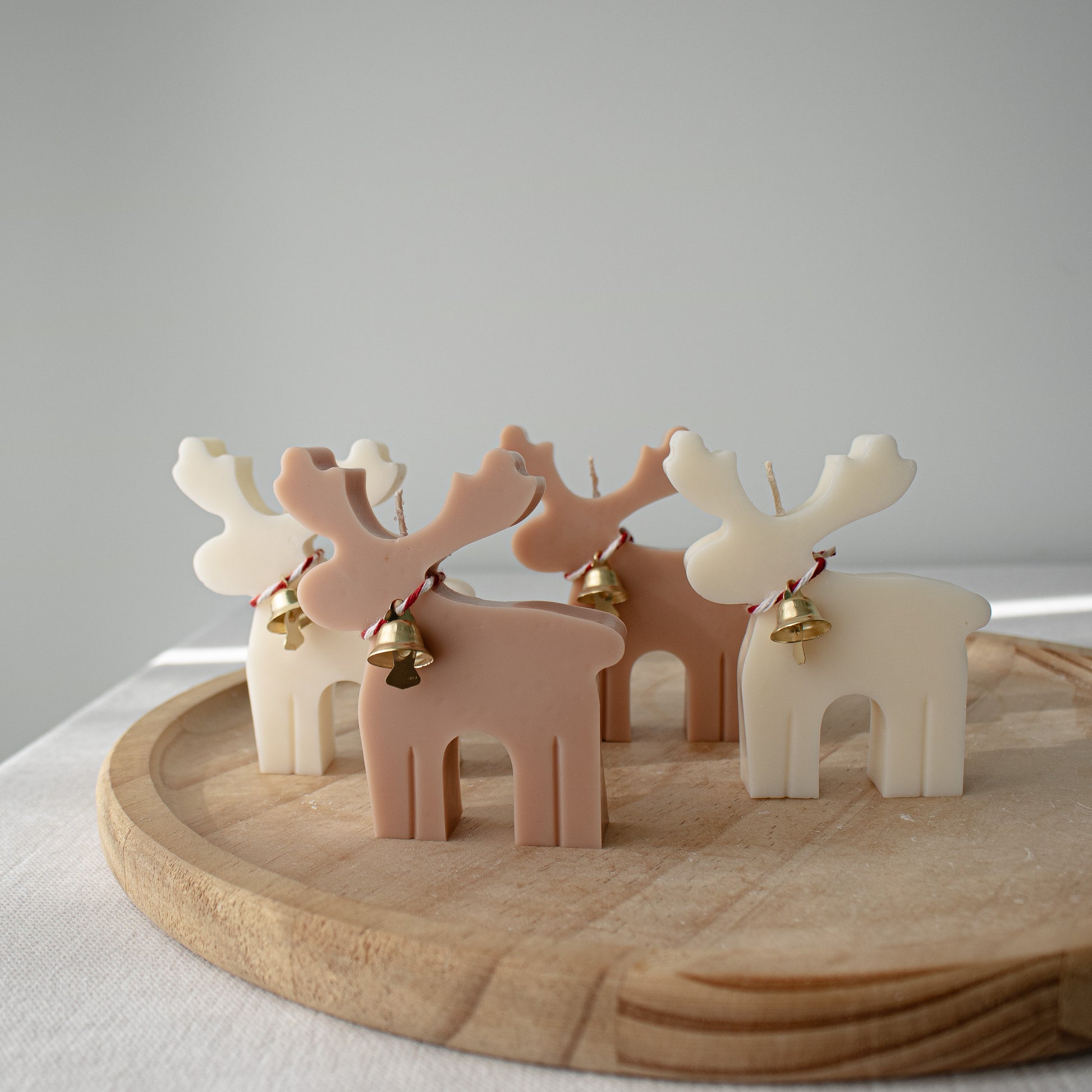 Set of reindeer-shaped candles with bells