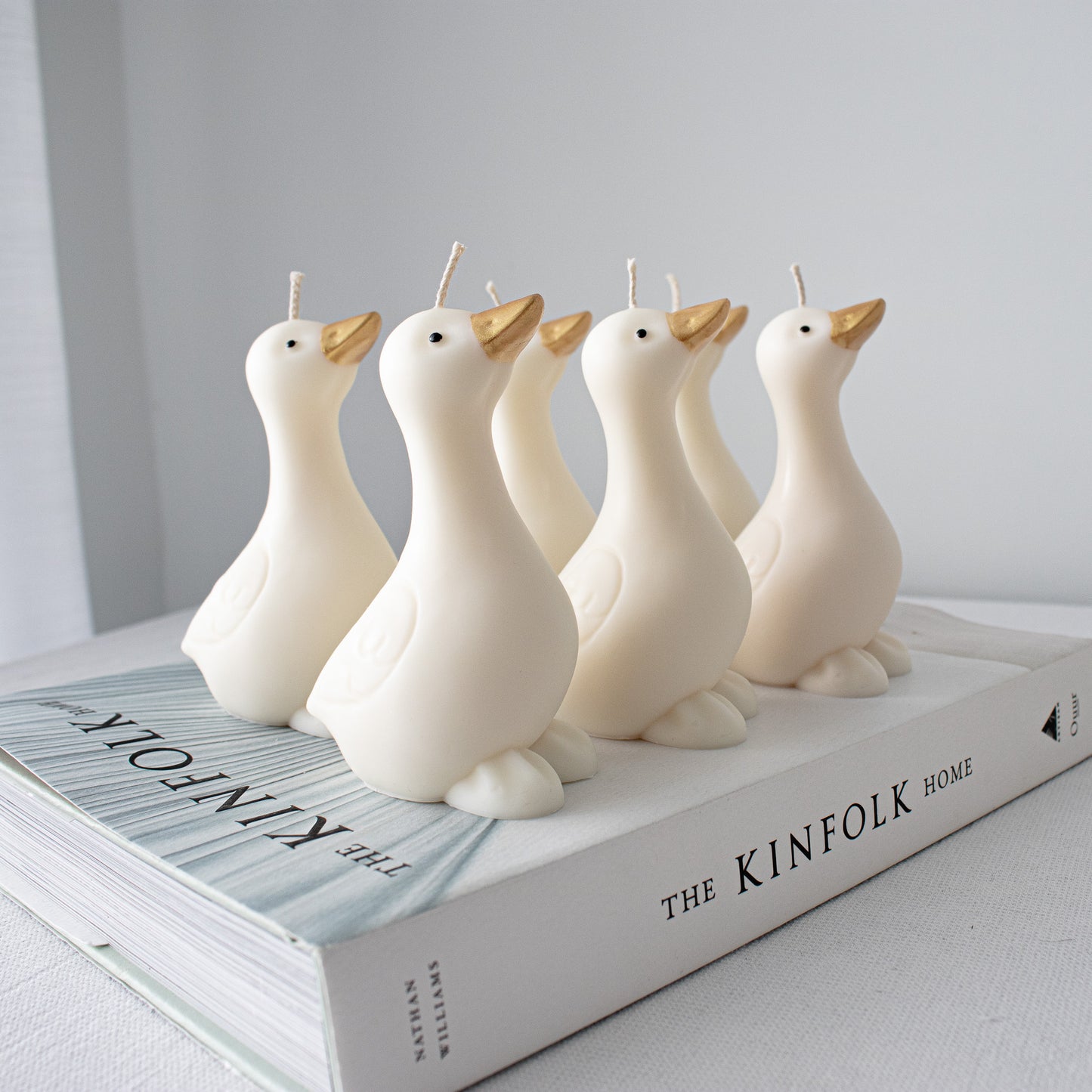 Handmade goose candles featuring hand-painted accents and minimalist farmhouse aesthetic
