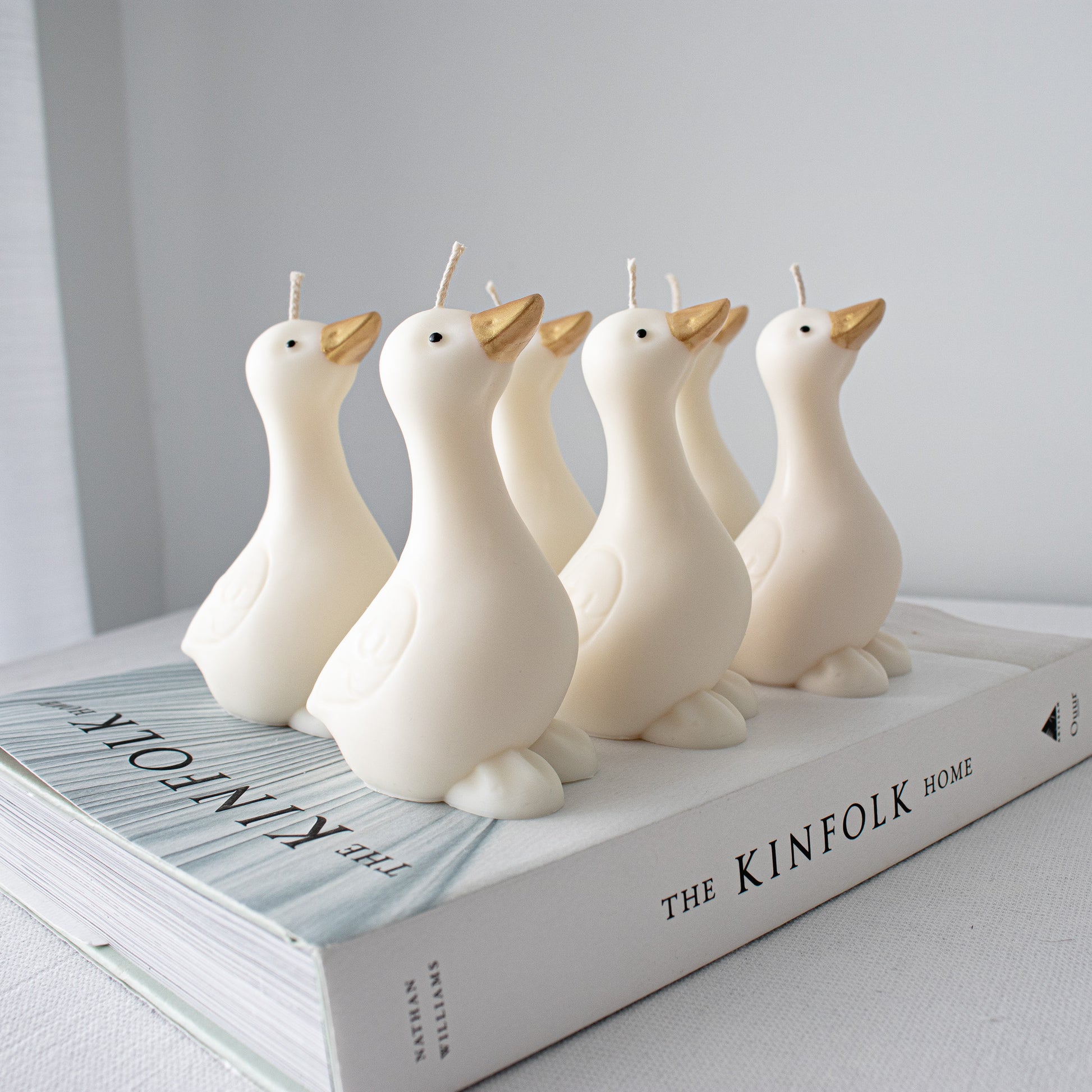 Handmade goose candles featuring hand-painted accents and minimalist farmhouse aesthetic