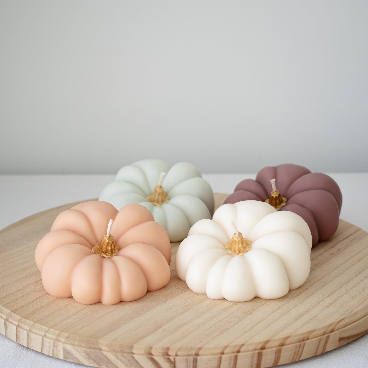 Colorful pumpkin candle collection with metallic gold stems